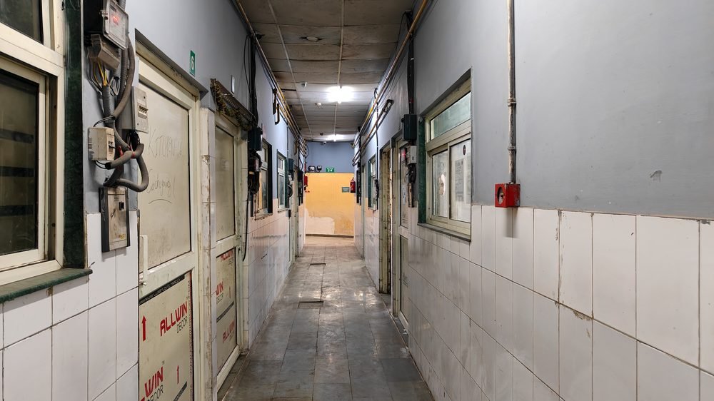 Tiled corridor lined with individual kitchen units at Blue Wings